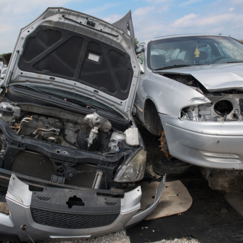 broken car parked in a junk car yard broken car parked in a junk car yard